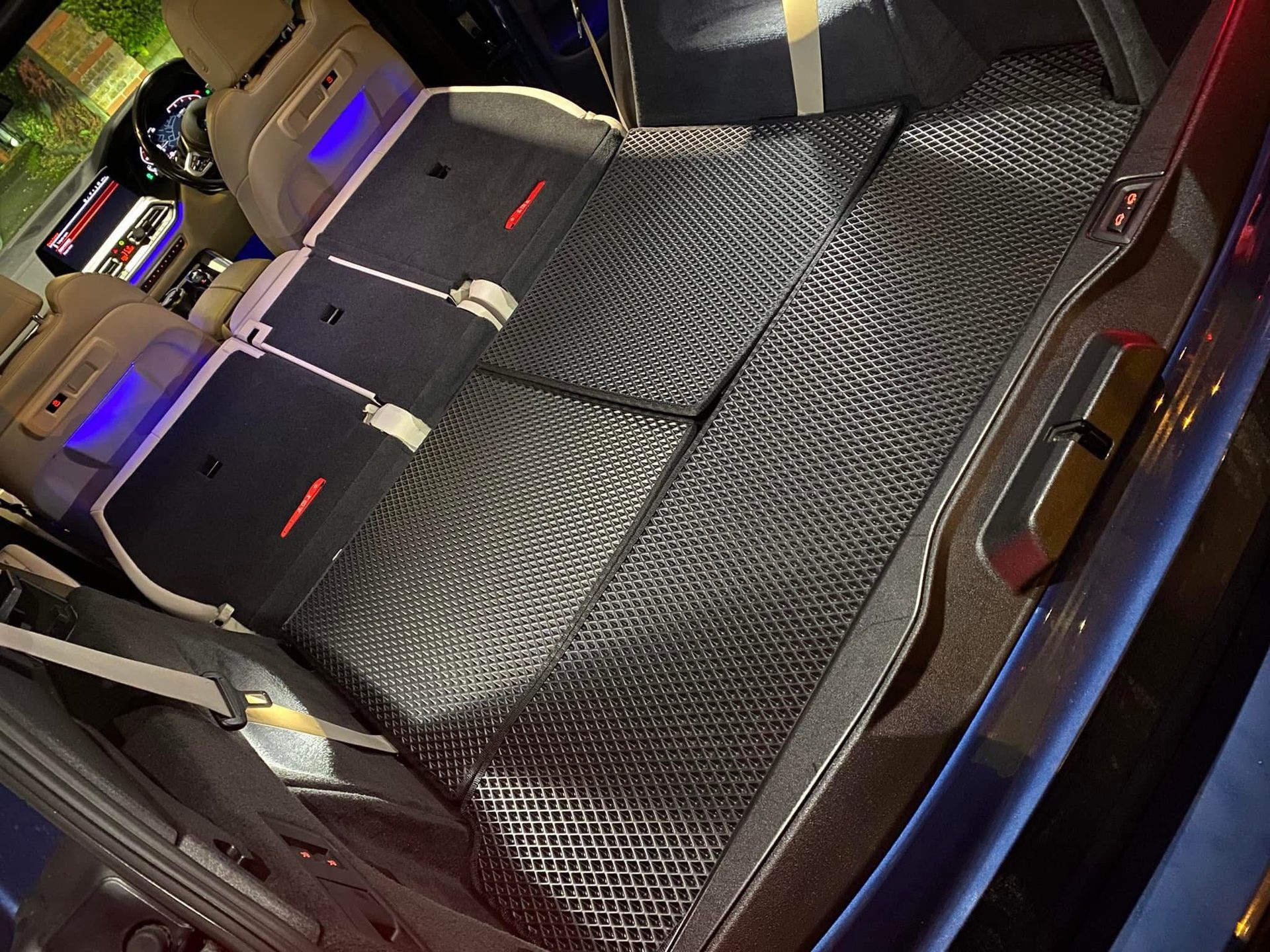 Black EVA mats fitted across a van rear floor